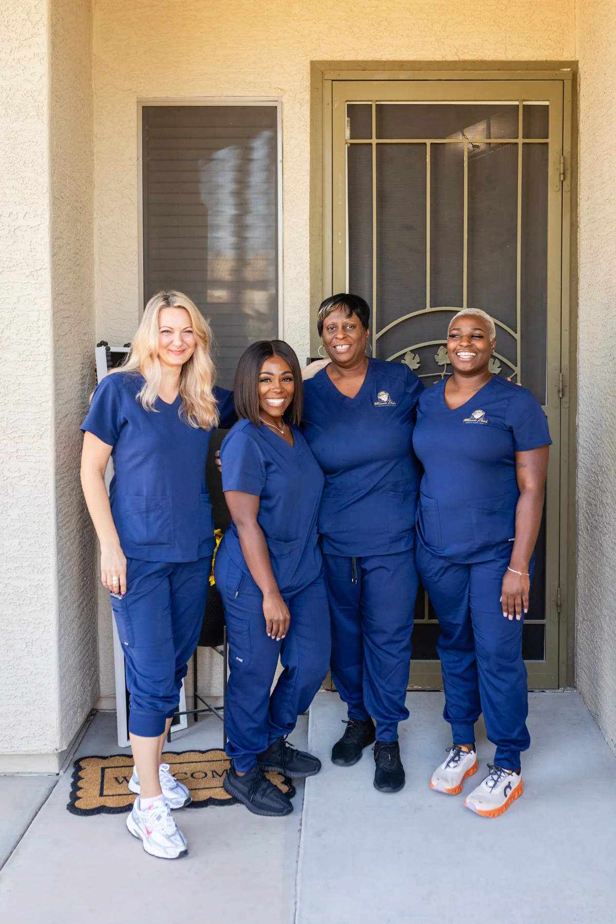 A group of people standing in front of a door.