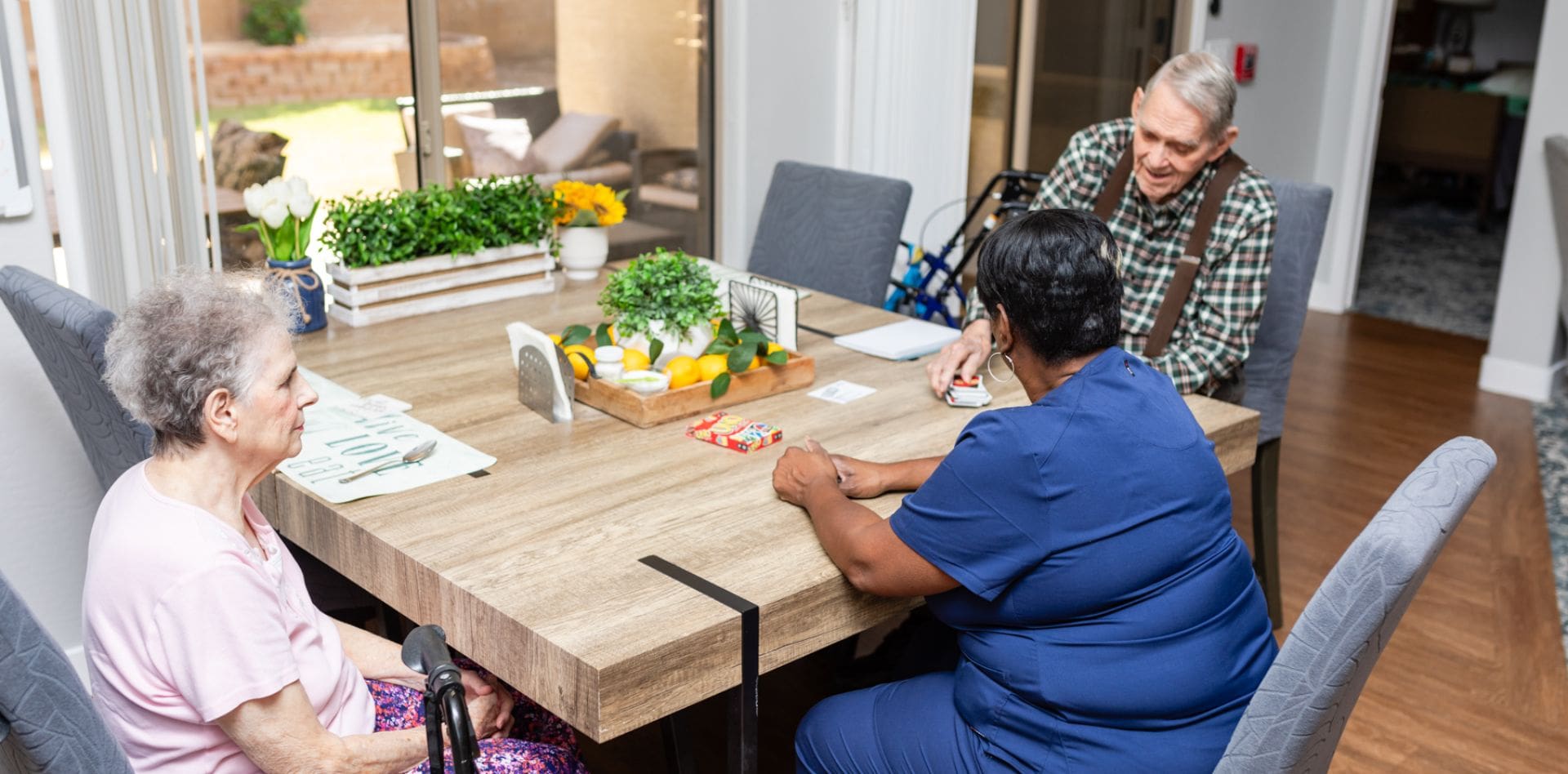 A man and woman sitting at a table with vegetables.