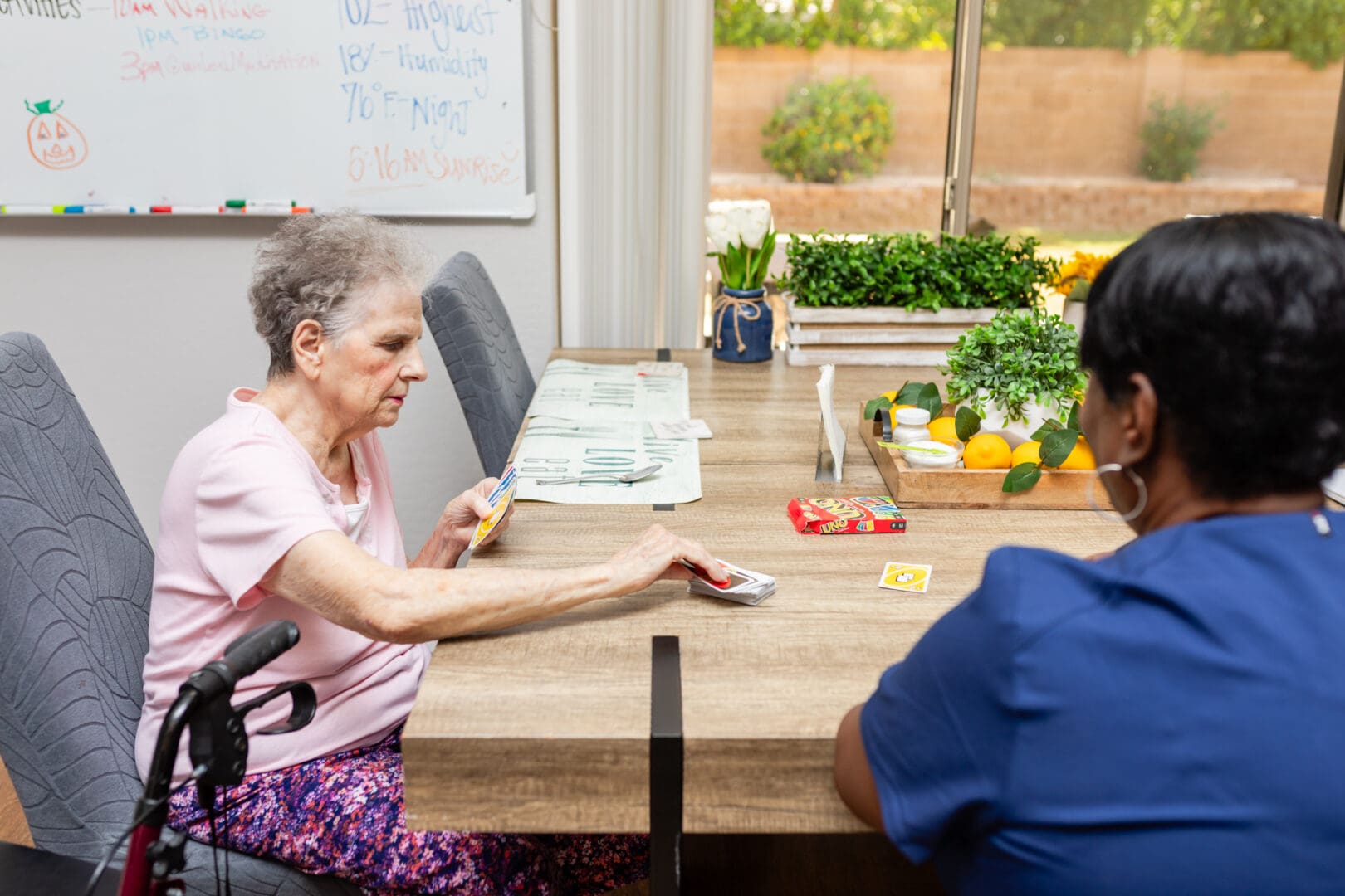 A woman sitting at the table with another person.