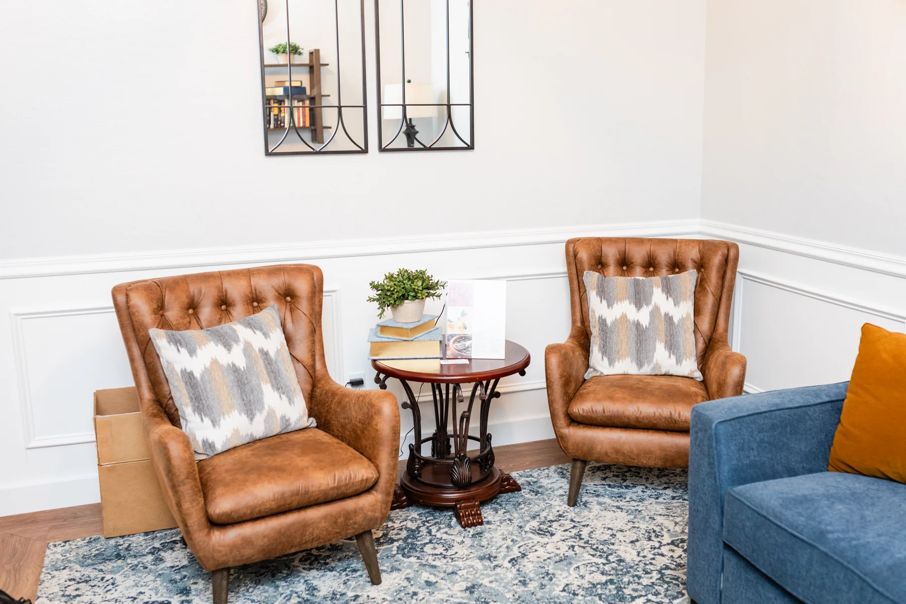 A living room with two chairs and a table