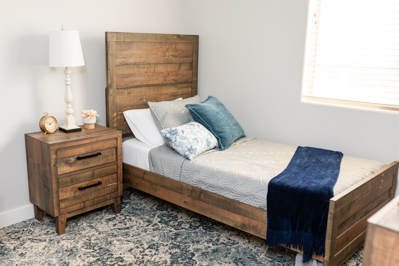 A bed and nightstand in a bedroom.